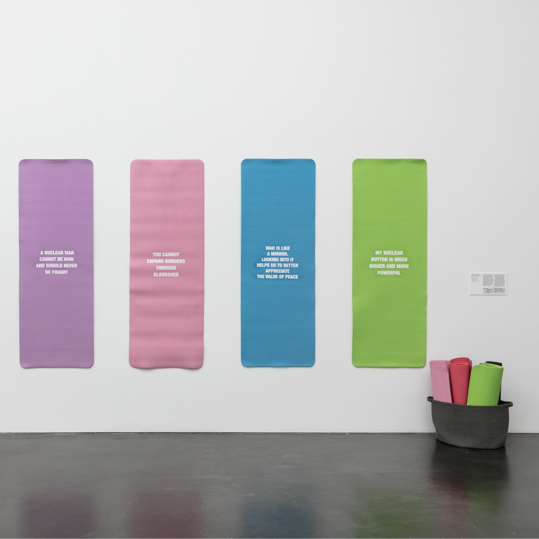 Colorful yoga mats hung on a wall.