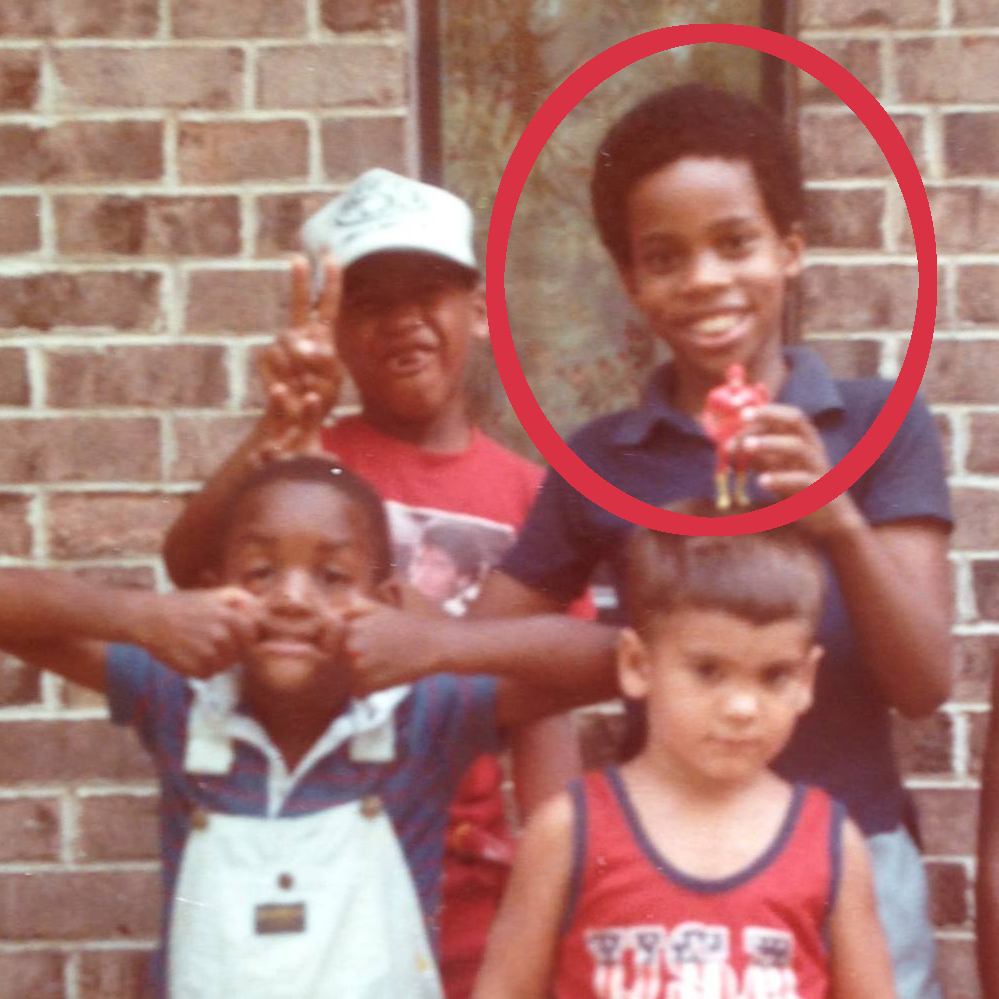 photo of young Alan Brooks holding a Flash character toy 