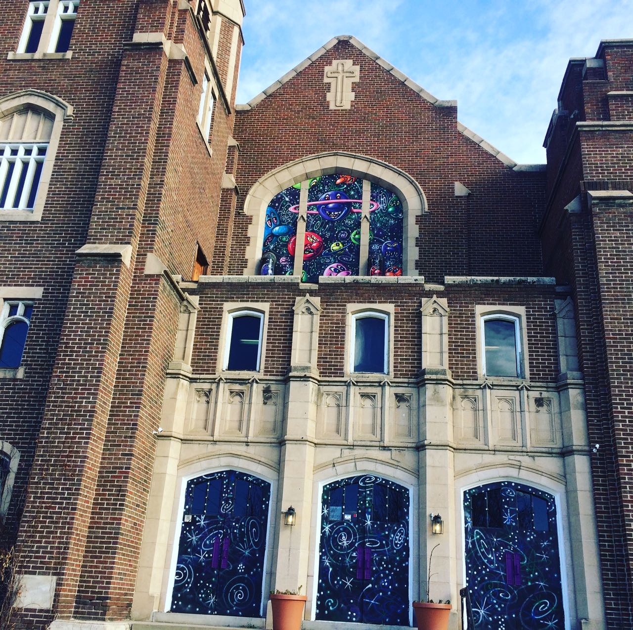 Church of CannabisA church. The glass stained windows have been painted over with depictions of planets and galaxies. 