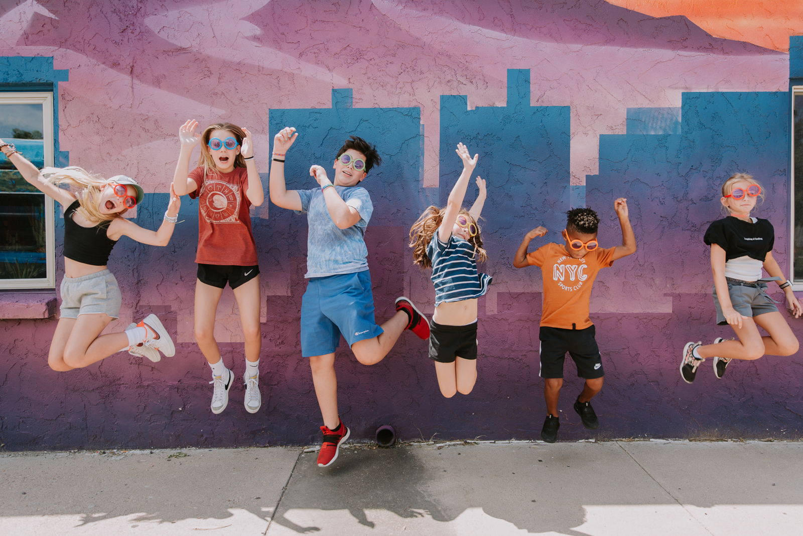 Kids jumping in front the building 