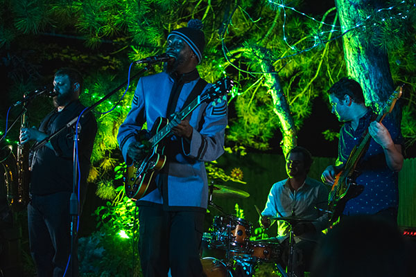 Photo of the band playing outside. Filter green on the background