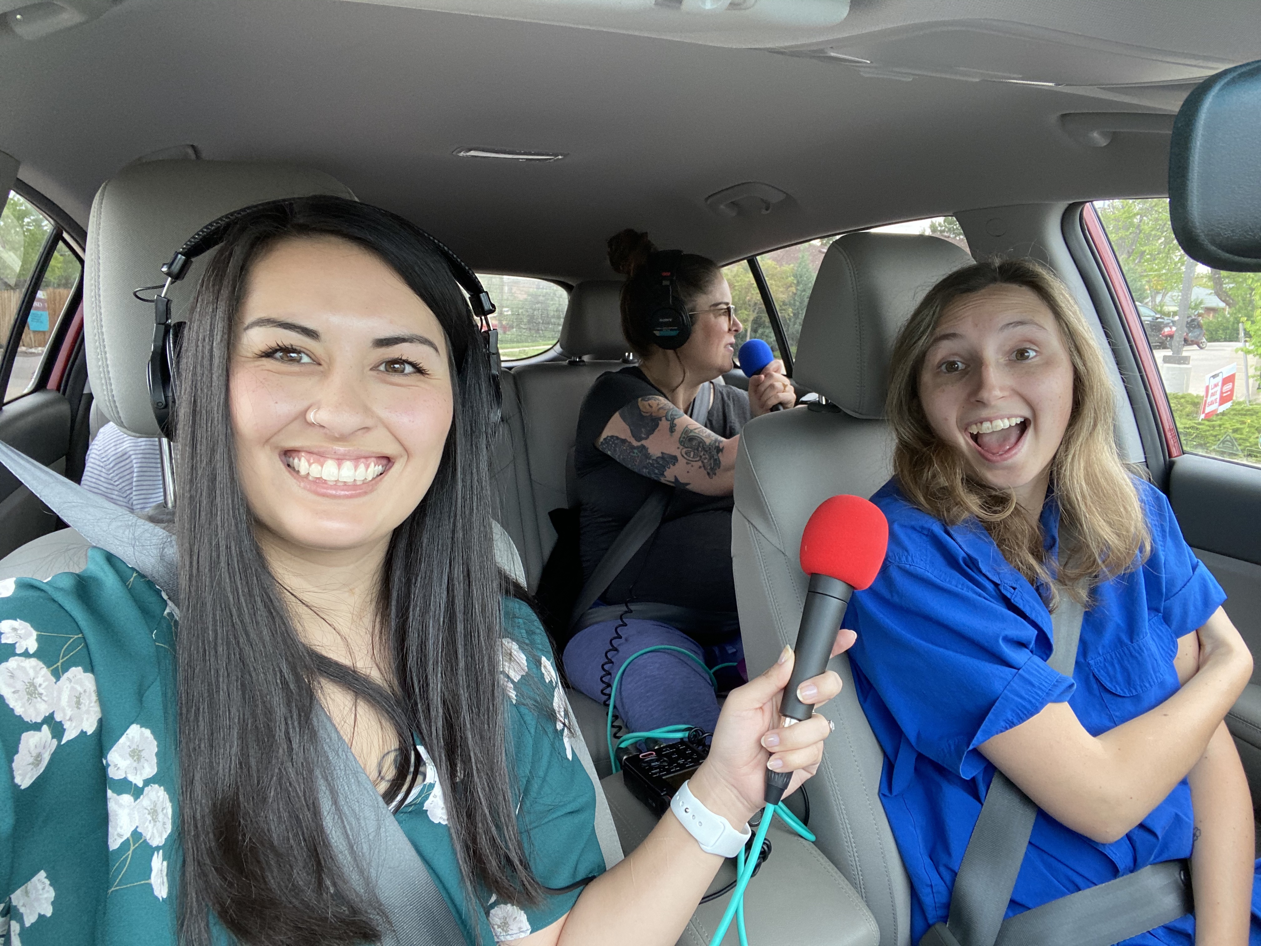 city cast team recording the podcast in a car