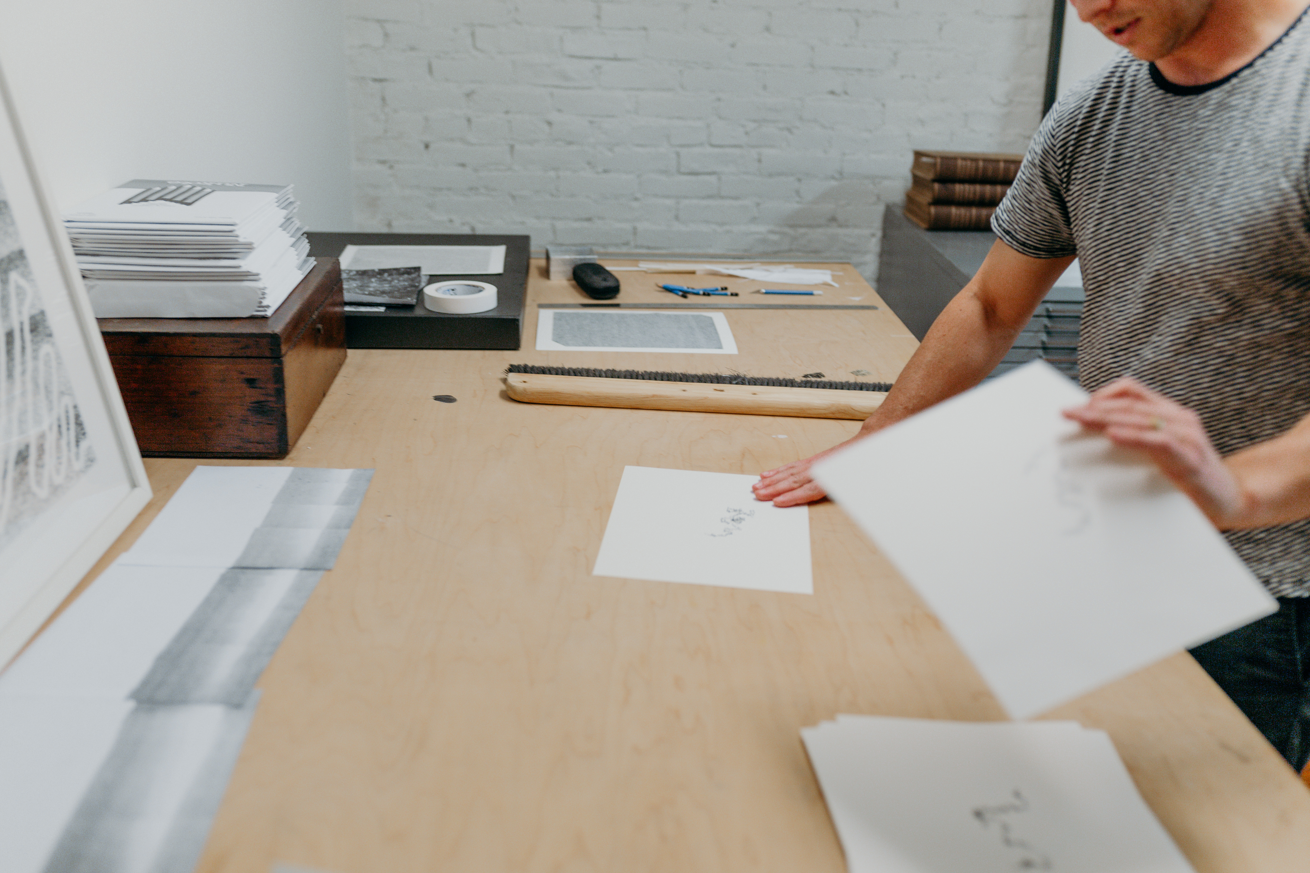 Candid shot of Chris Oatey going through papers at a wooden desk. ﻿