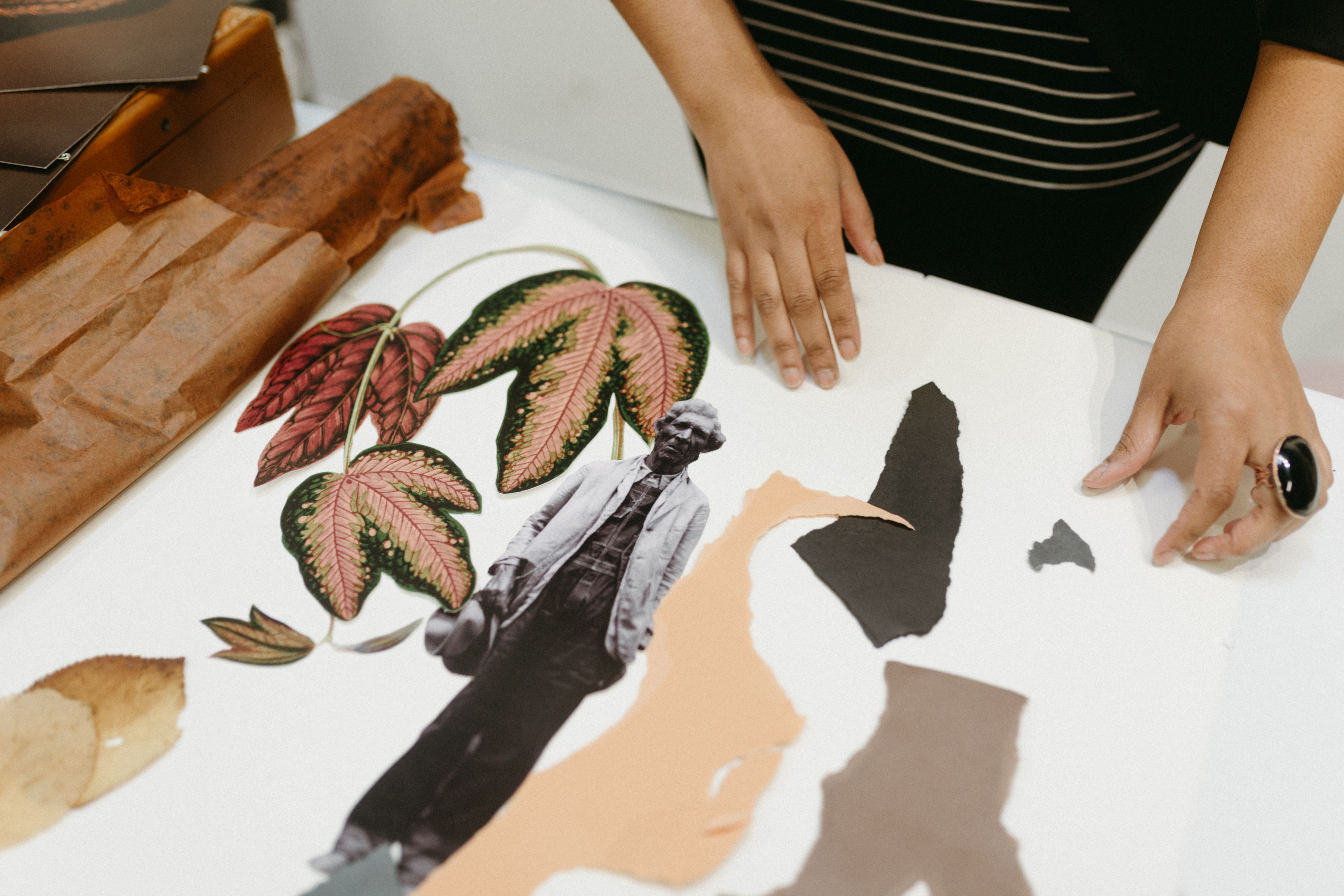 Anthony working on a collage on a table