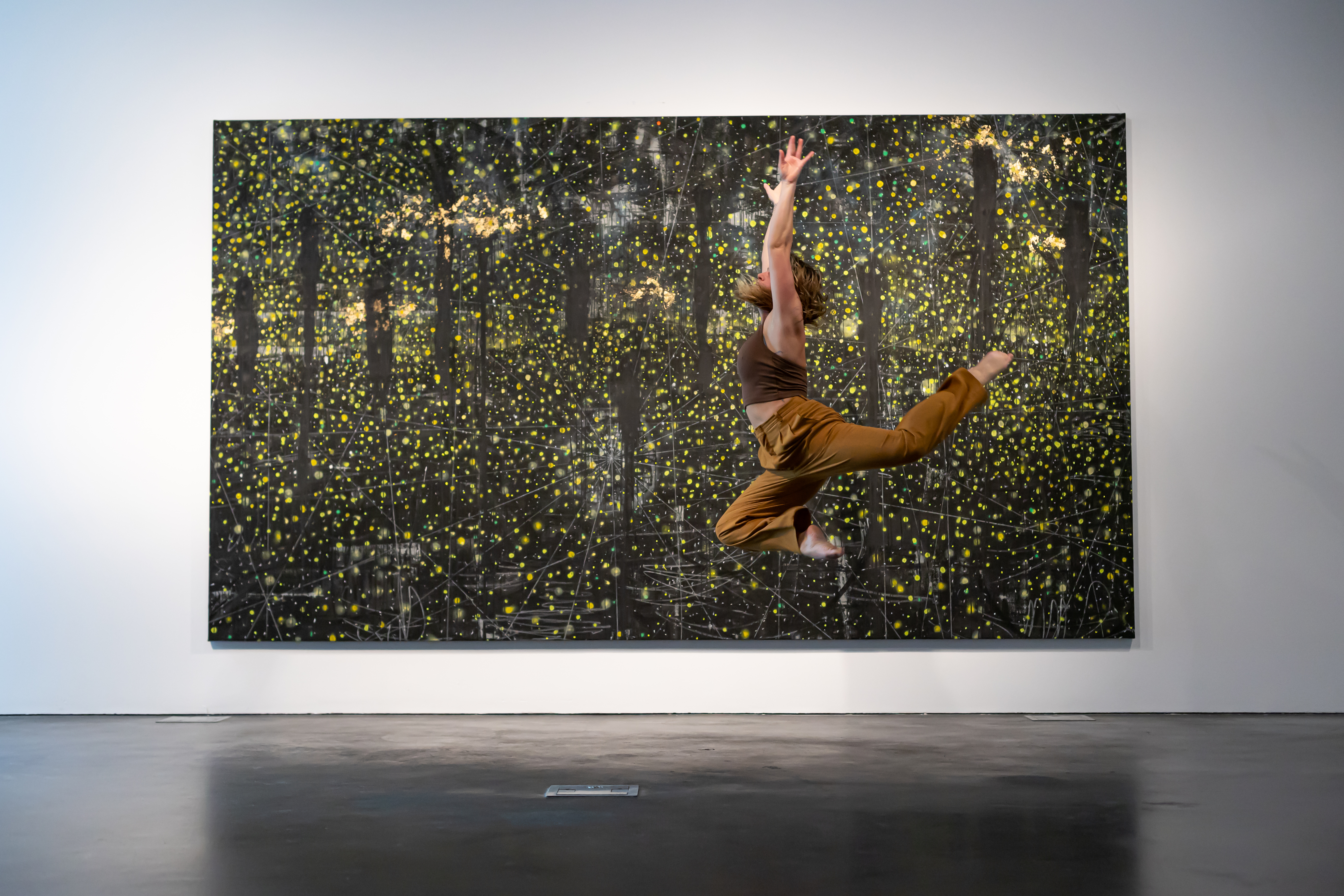 Dancer in front of artwork in The Dirty South at MCA Denver